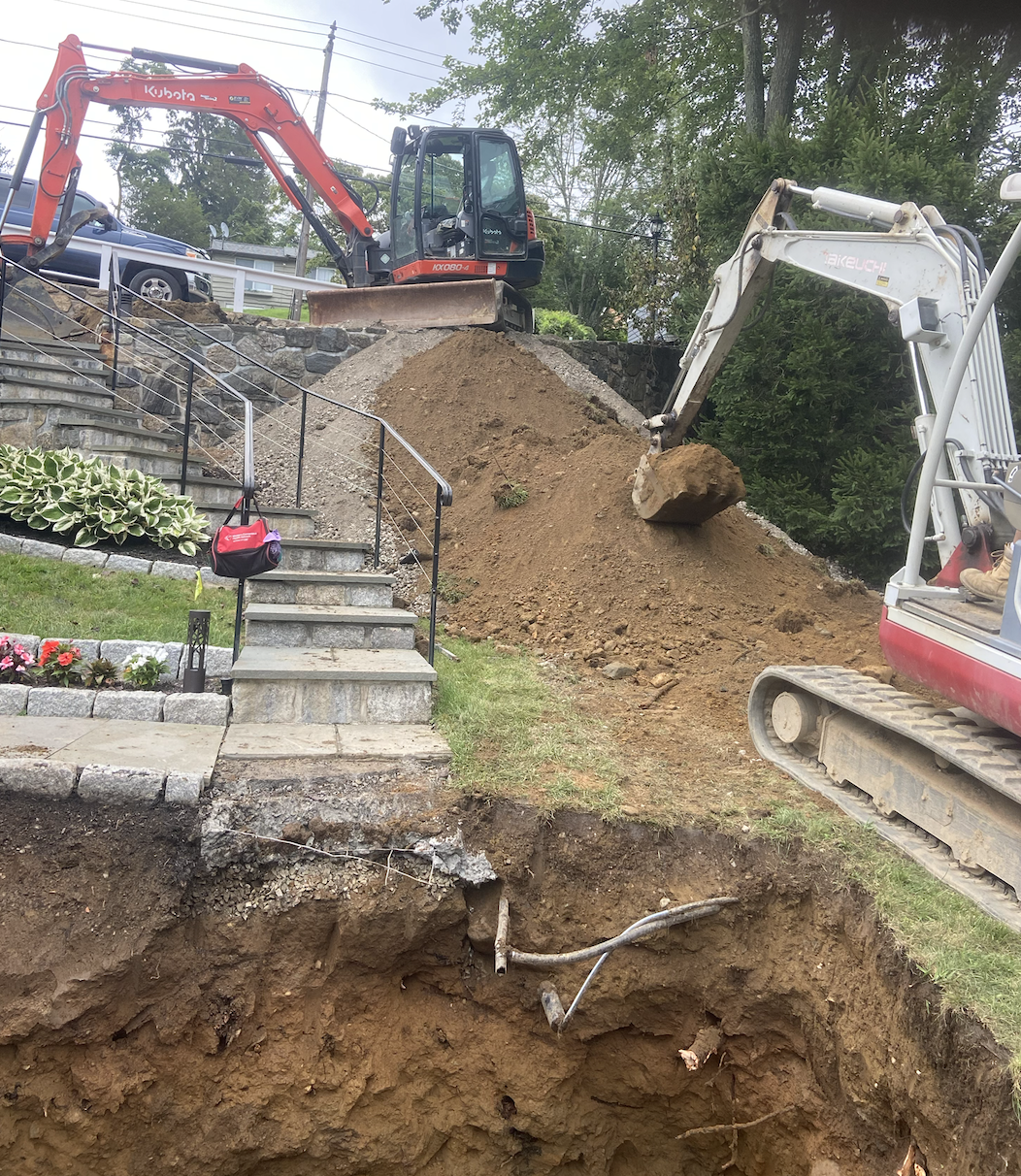 AJM Septic and Excavating team building a slope down to a septic tank.